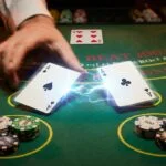 Pair of Aces being split on blackjack table with energy effect showing the splitting action, dealer card visible