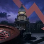 Illinois state capitol at night with casino roulette wheel and chips in foreground with red downward arrow symbolizing gambling revenue decline from aggressive tax policy